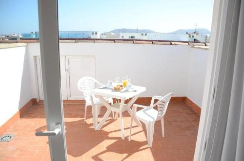 a white table and chairs on a balcony at Cotillo Ocean View in Cotillo