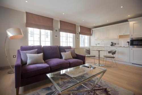 a living room with a purple couch and a table at No.8 Waterloo Street in Birmingham