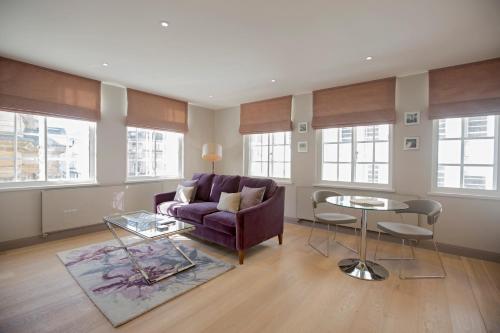 a living room with a purple couch and a table at No.8 Waterloo Street in Birmingham