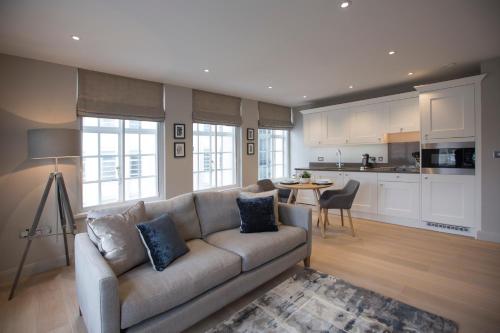 a living room with a couch and a kitchen at No.8 Waterloo Street in Birmingham