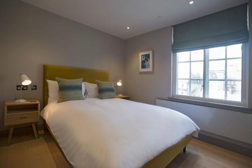 a bedroom with a large white bed and a window at No.8 Waterloo Street in Birmingham