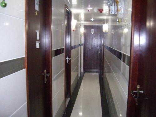 a corridor of a hallway with two doors and a hallway at CANADIAN Hostel in Hong Kong