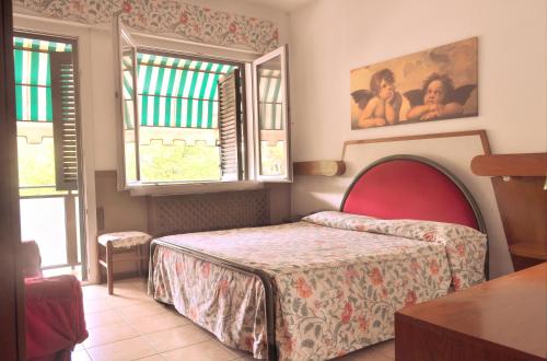 Ένα ή περισσότερα κρεβάτια σε δωμάτιο στο Hotel Roma