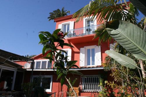 a red house with a tree in front of it at Hôtel La Villa Patricia - Charme et Tradition in Villefranche-sur-Mer