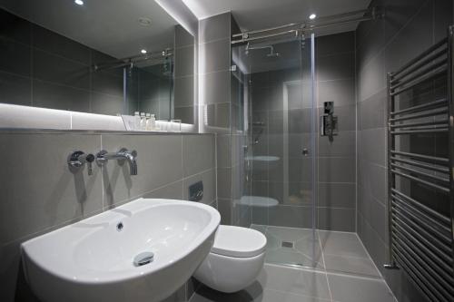 a bathroom with a sink and a toilet and a shower at No.8 Waterloo Street in Birmingham