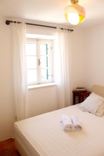 a bedroom with a bed with two towels on it at Villa St Roko - Charme Holidays in Sutivan