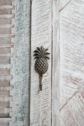 a pineapple door knocker on the side of a building at Captain Coconuts Gili Air in Gili Air