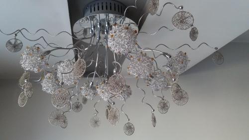 a chandelier is hanging from a ceiling at Apartament Charisma in Zakopane