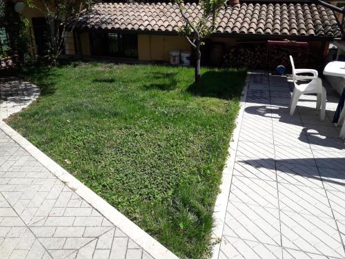 
a grassy area with a lawn chair and a lawn mower at B&B Porta Bazzano in LʼAquila
