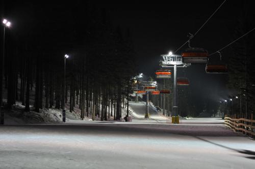 an empty street at night with a ski lift at Hotel Vivaldi in Karpacz