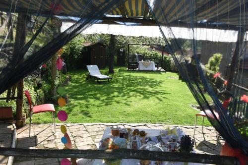 a view of a backyard with a table in the grass at B&B Va...lentina in Piavata