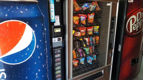 a vending machine filled with lots of chips and soda at Carriage House Inn in Branson