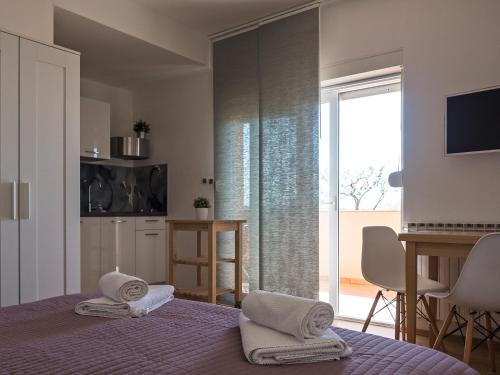 a bedroom with a bed with towels on it at Apartments Nino 1 in Zadar