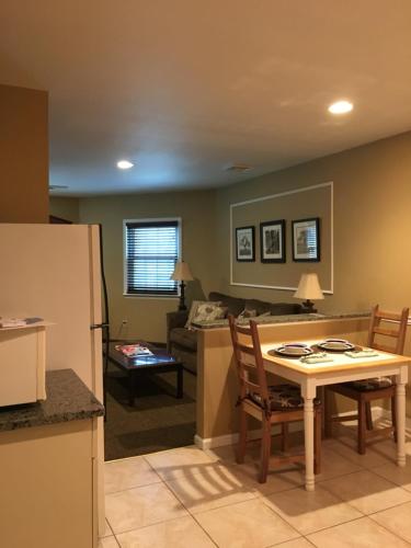 a kitchen and living room with a table and a couch at Whitman Motor Lodge in Huntington