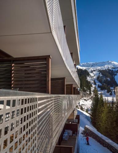 a balcony of a building with a view of a mountain at CGH Résidence Boutique Le Centaure in Flaine