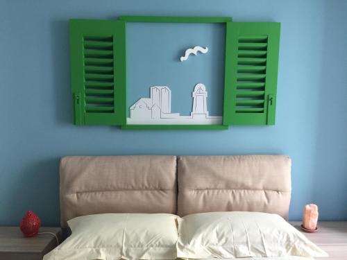a bedroom with a bed and a blue wall at B&B Mareè Seafront Molfetta in Molfetta