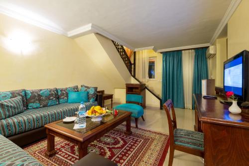 a living room with a couch and a table at Kennedy Hospitality Resort in Marrakech