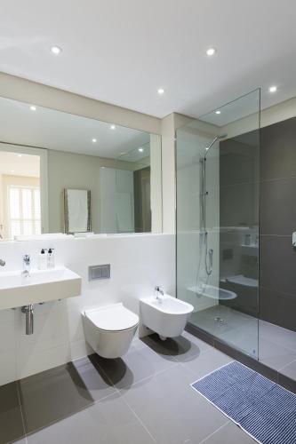 a bathroom with two sinks and a shower at 005 Marina Apartment in Cape Town