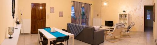 a living room with a couch and a table at Sofoklis Apts in Stalos