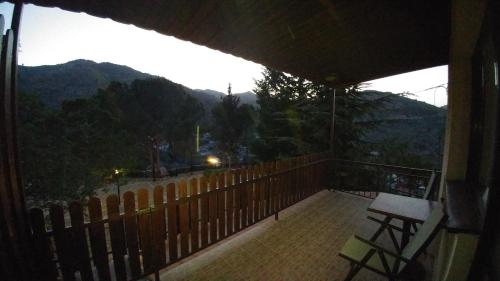 a balcony of a house with a view of the mountains at Perneia Rooms in Askas