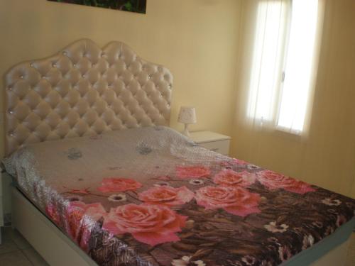 a bedroom with a bed with flowers on it at Las Floritas in Playa de las Americas