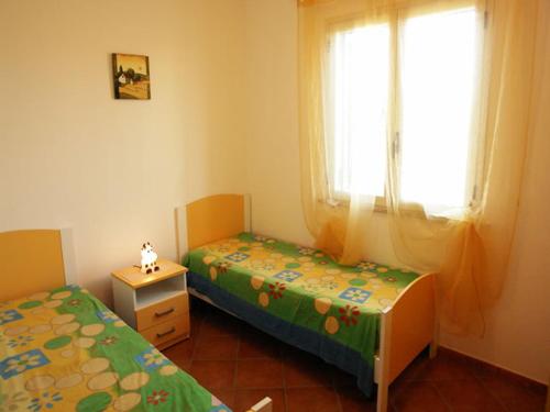 マリーナ・ディ・マンカヴェルサにあるVille Amalfiのベッドルーム1室(ツインベッド2台、窓付)