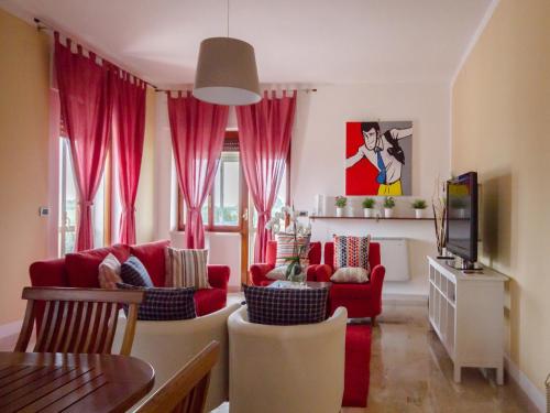 uma sala de estar com mobiliário vermelho e cortinas cor-de-rosa em B&B Costa D'Abruzzo em Fossacesia