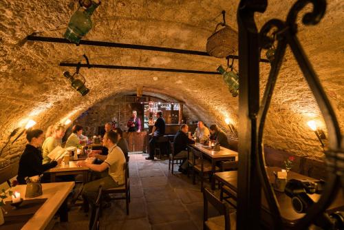 a restaurant with people sitting at tables in a tunnel at Romantik Hotel Deutsches Haus in Pirna