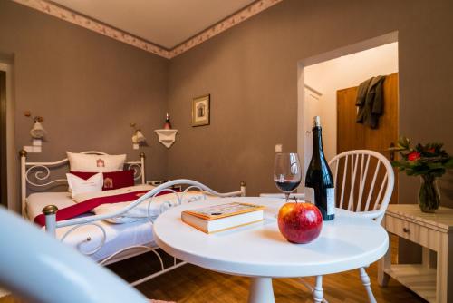 a bedroom with a bed and a table with an apple on it at Romantik Hotel Deutsches Haus in Pirna