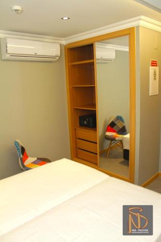 a bedroom with a bed and a mirror at Rocha Prestige - Guest House and Suites in Portimão