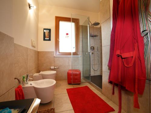 a bathroom with a toilet sink and a shower at Villa Anna in Santa Teresa di Riva