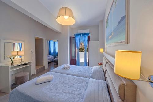 a bedroom with a large white bed in a room at Paradise in Ermoupoli
