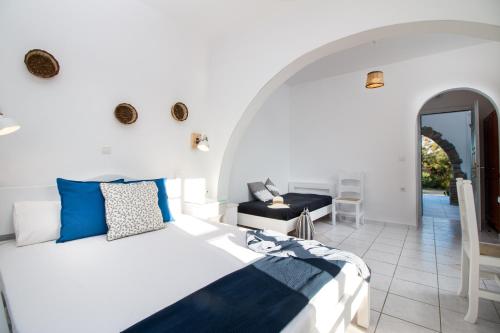 a bedroom with a bed and a desk at Ktima Bianco in Naxos Chora