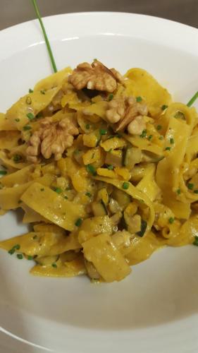 a white plate of pasta with meat and sauce at Gasthof Specker in Obereggen