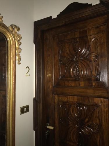 a wooden door with the number on the wall at Casa Palacio VillaZambra in Ronda