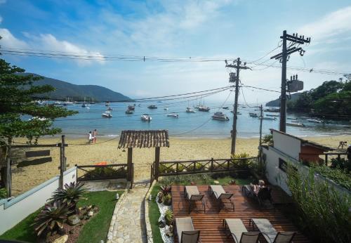 a view of a beach with boats in the water at Pousada Caiçara in Abraão