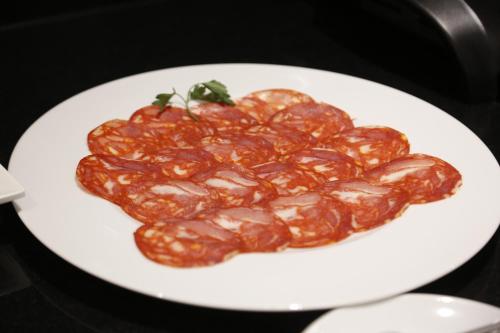a white plate of food on a table at Hotel Ponte Sor in Ponte de Sor