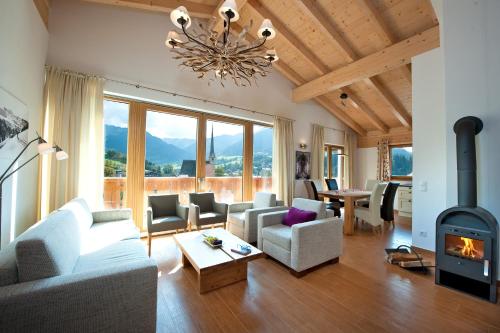 a living room with a fireplace and a couch at AlpenParks Apartments Maria Alm in Maria Alm am Steinernen Meer