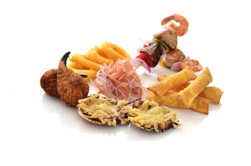 a group of different types of food on a white background at Hotel Hacienda Abraspungo in Riobamba