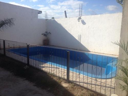 a fence around a swimming pool next to a building at Chilo Hotel in Termas de Río Hondo