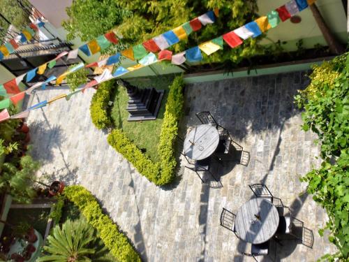 an overhead view of a patio with tables and flags at Shakya House in Pātan