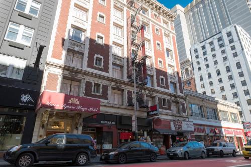 a city street with cars parked in front of buildings at Union Square Plaza Hotel in San Francisco
