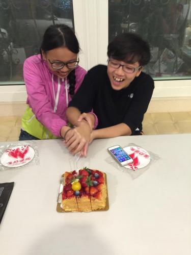 a man and a woman cutting into a cake at Doll House Lodge in Hengchun