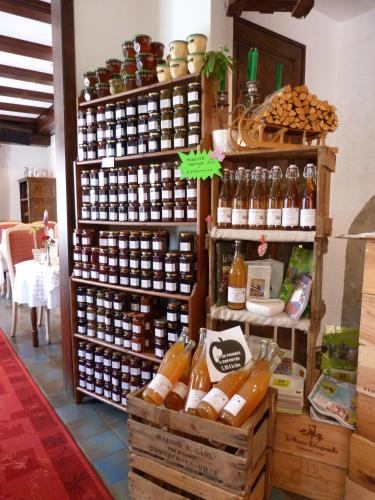 a store filled with lots of bottles of alcohol at Logis Hôtel Restaurant La Petite Auberge Alsace in Le Hohwald
