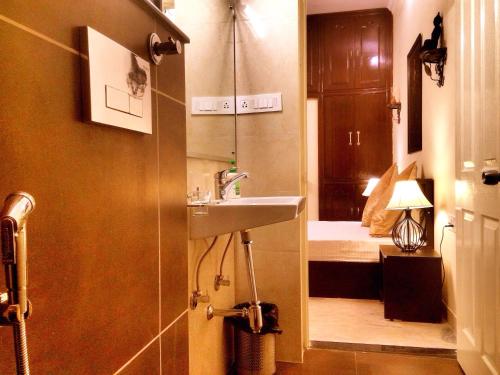 a bathroom with a sink and a bath room at The Buddhayan Villa in Jaipur