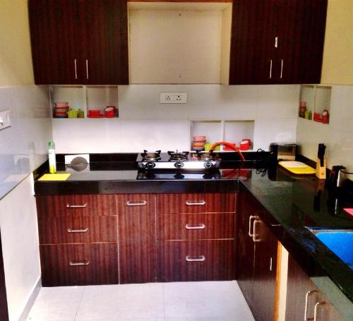 a kitchen with wooden cabinets and a sink in it at The Buddhayan Villa in Jaipur