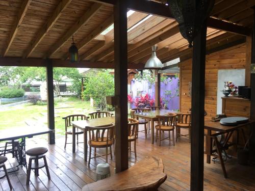 a dining room with tables and chairs on a wooden floor at Moon River Villa in Puli