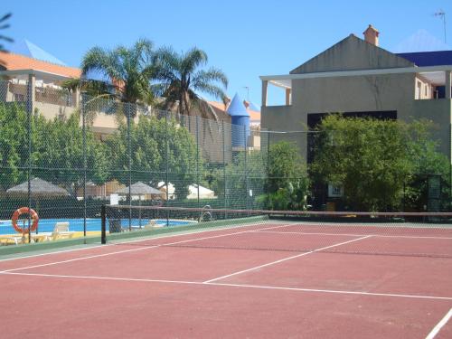 a tennis court with a net on a tennis court at Islantur Ipanema in Islantilla