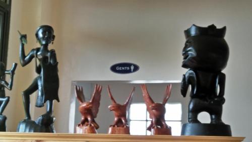 a shelf with a group of statues on it at Banaue Sunrise Guest House in Banaue
