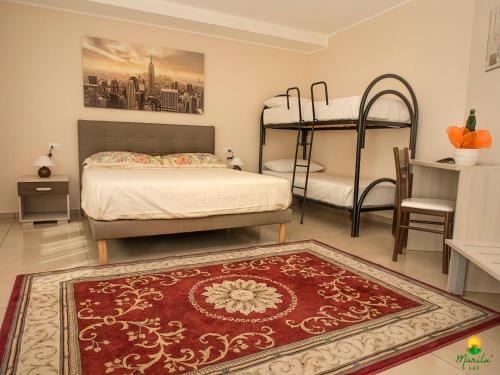 a bedroom with two bunk beds and a red rug at Marilù B&B in Matino